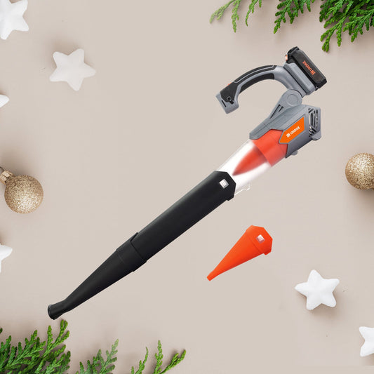 Cordless electric leaf blower and nozzle on festive background with pine branches and ornaments