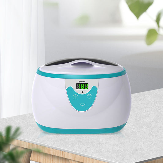 Digital ultrasonic cleaner with teal accents on a countertop in a bright room